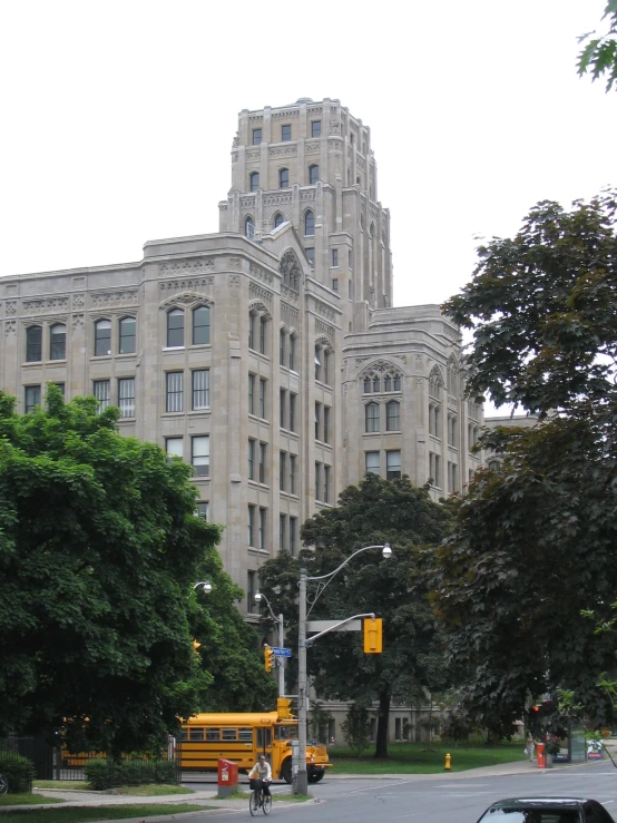 a school bus is seen in front of a large building