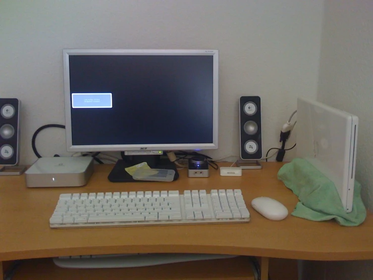 the desk has a desktop computer with two speakers next to it