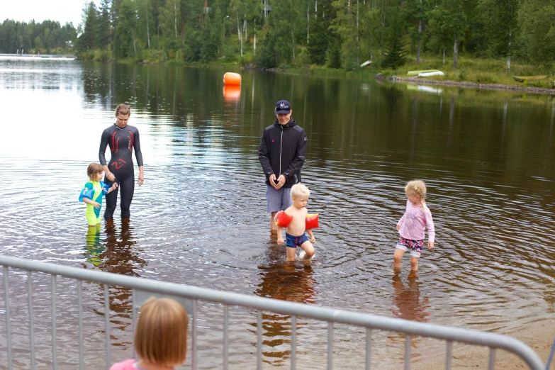 there are people playing in the water with children