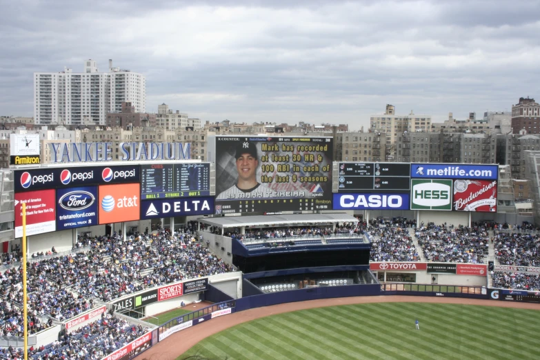 a stadium with lots of people watching televisions and sporting events