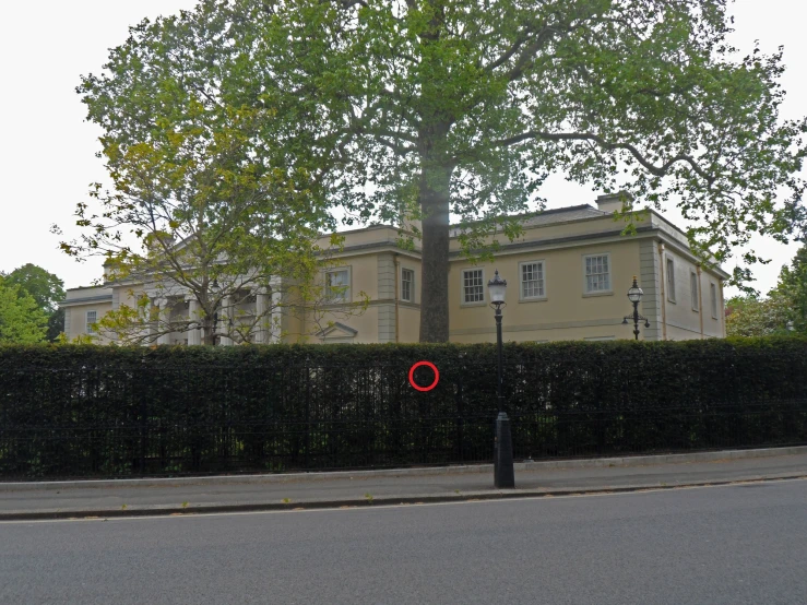 a red object is sitting on the side of the road