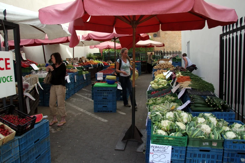 a woman that is standing in front of a produce stand