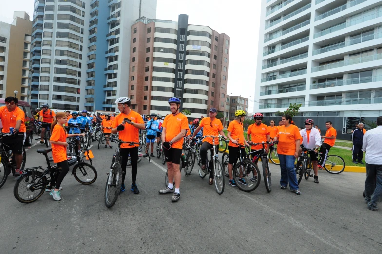 many bicycle riders are in an orange shirt