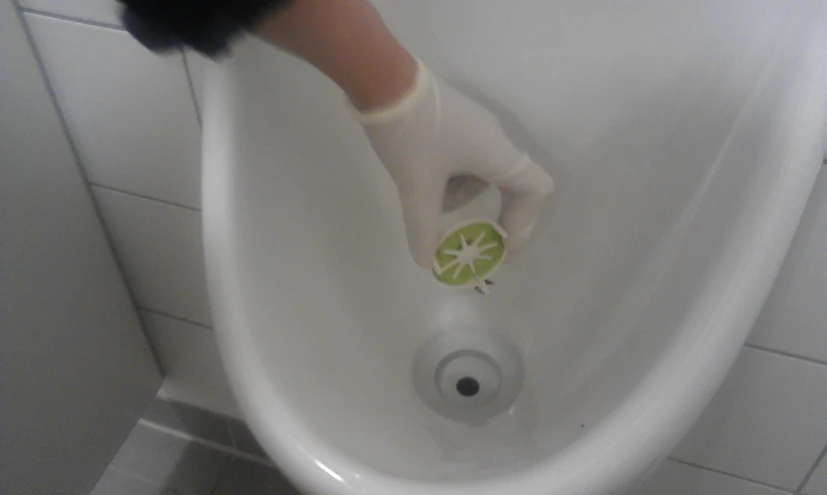 a person cleaning the floor in a bath room