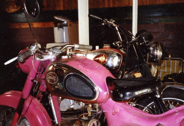a red motor bike with a pink paint job