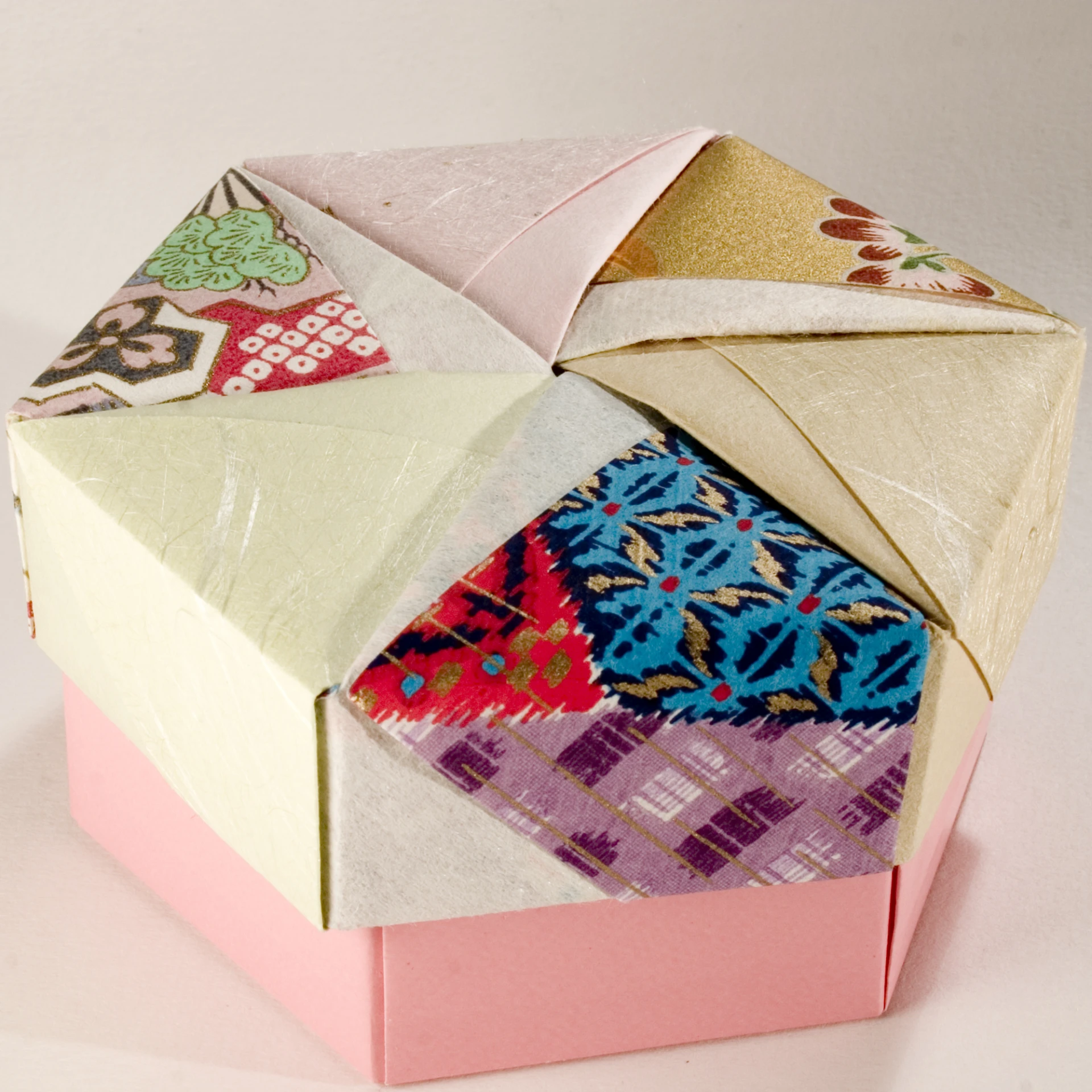 a small decorative colorful box is folded and stacked