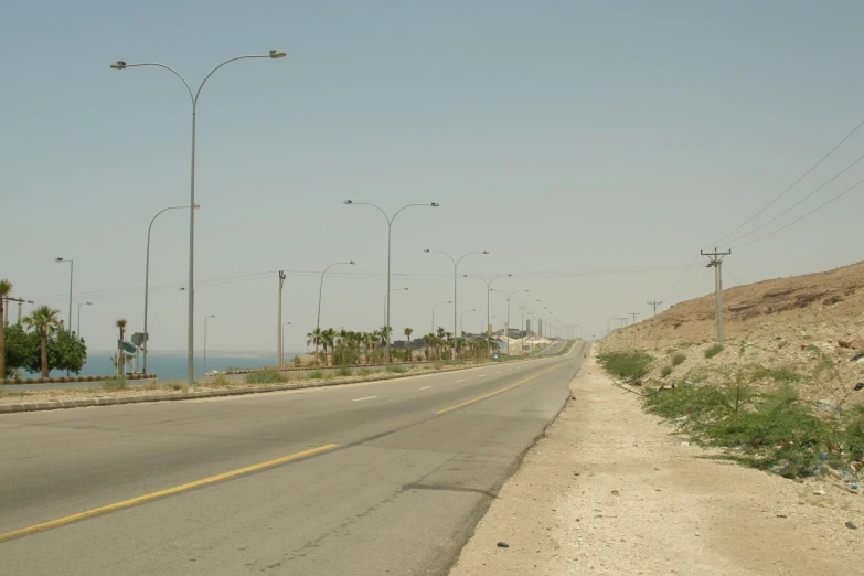 an empty road is in the middle of some vegetation