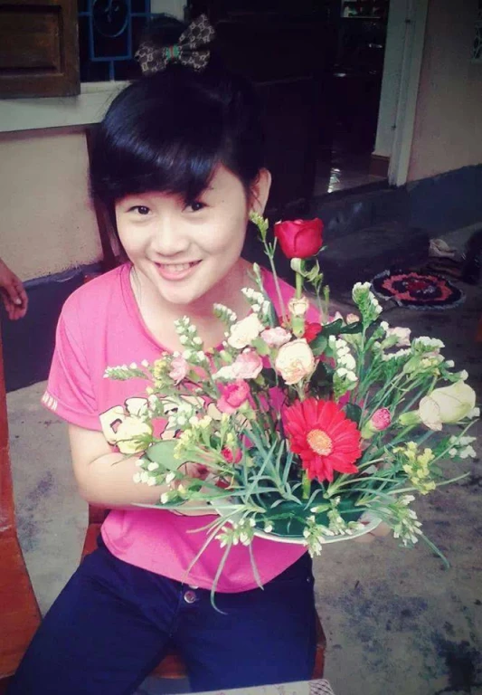 girl posing for camera with a bouquet of flowers