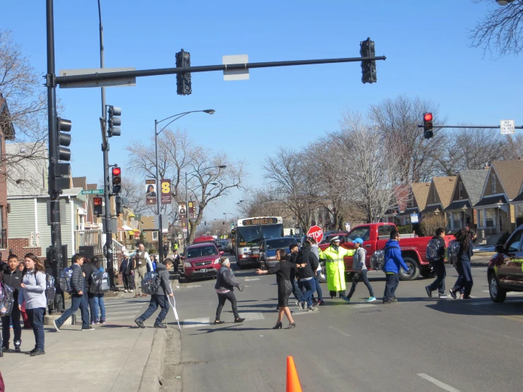 people are on the street under traffic lights