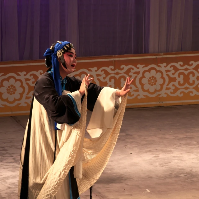 a person in costume doing a trick on stage