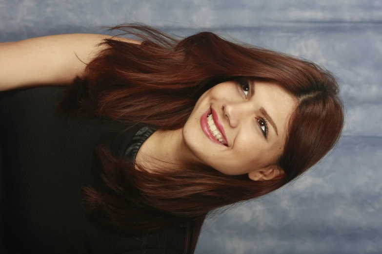 a young woman posing for the camera smiling