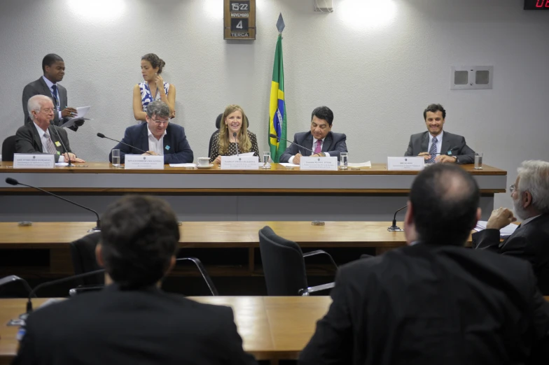 a panel of men and women sitting at table