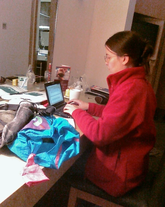 a woman sitting at a desk using a laptop