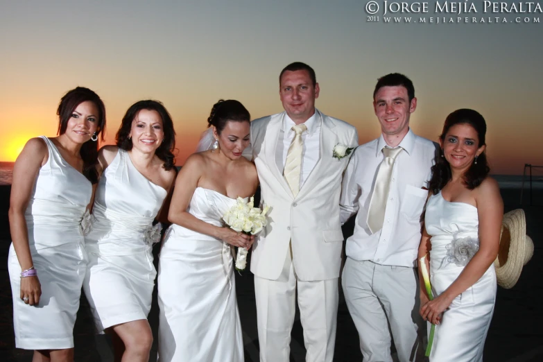 a group of people dressed in wedding clothes