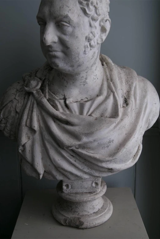 a bust of an old man in roman plaster