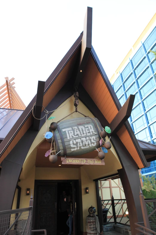 a small wooden house with sign above it