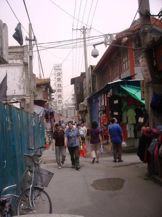 several people are walking around on the side walk