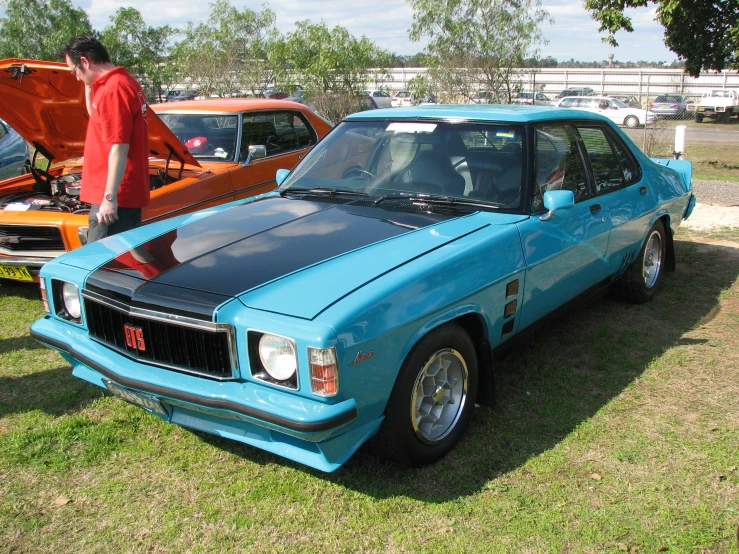 a blue and black car at a car show