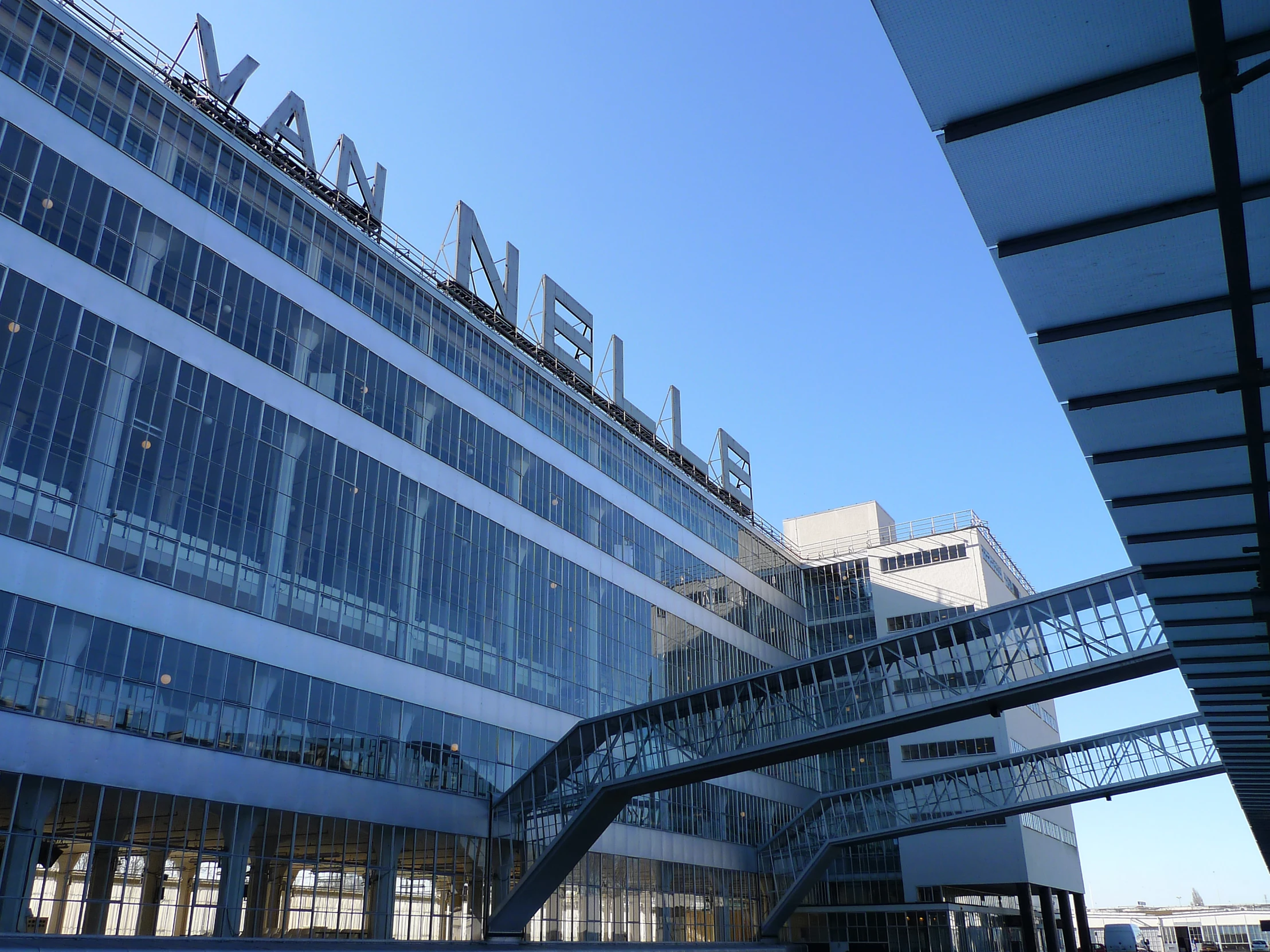 modern glass building with metal railings in front