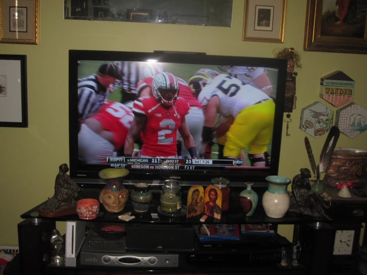 a tv on top of a wooden stand