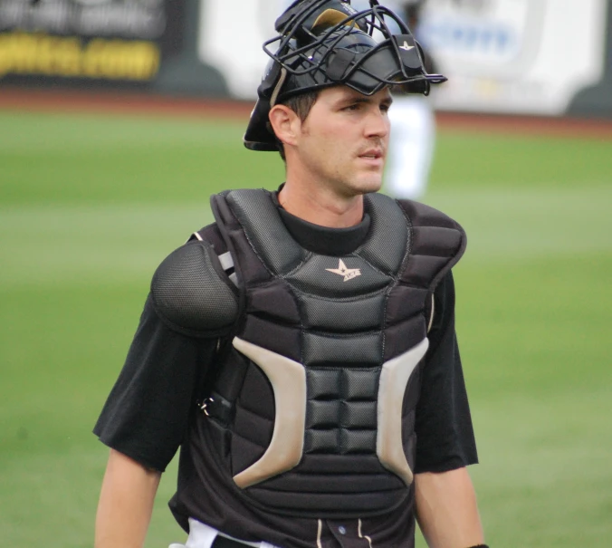 a baseball player wearing catchers gear in the field