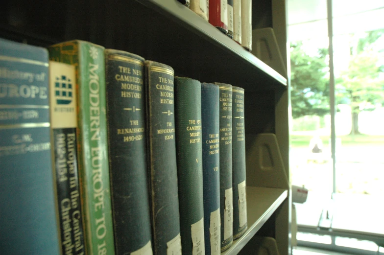 books sitting on a book shelf in the liry