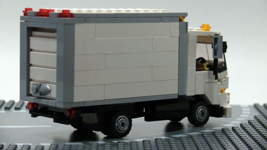 the truck is made out of legos and has no roof