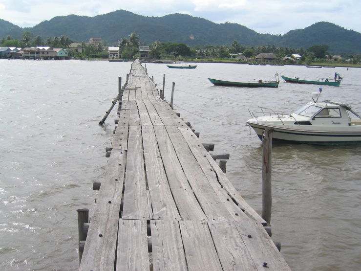 a long dock with lots of small boats