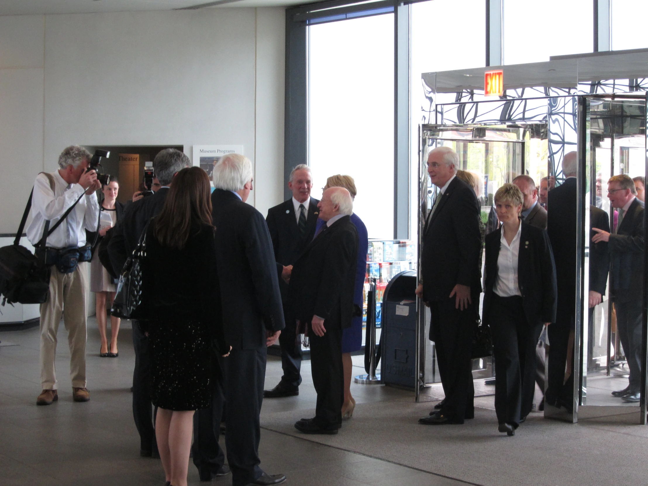 several people are standing outside of an elevator