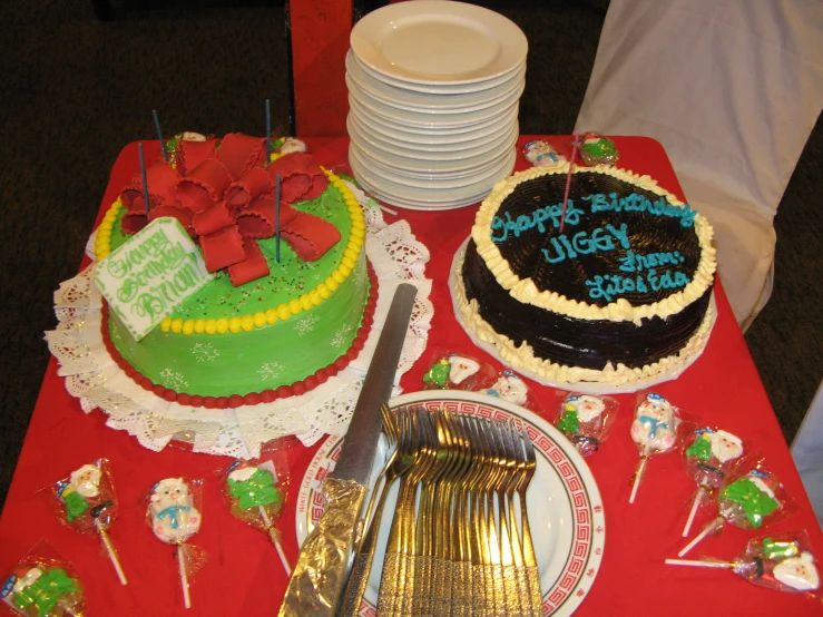 two birthday cakes on a table in a party setting