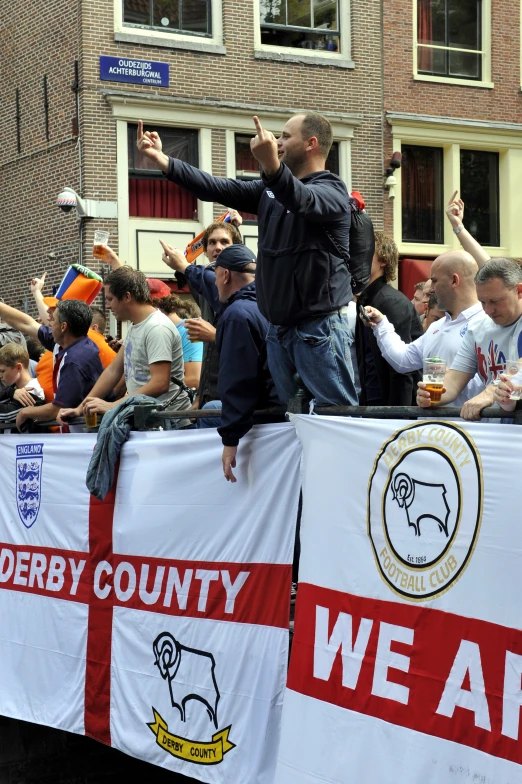 a man taking pictures while riding on the back of a truck