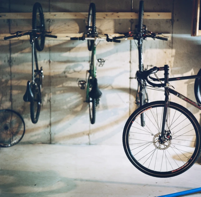 bicycles hanging on hooks and in an indoor bike shop