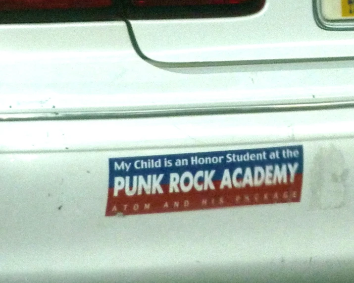 the trunk of a car with a pink rock academy sticker on it