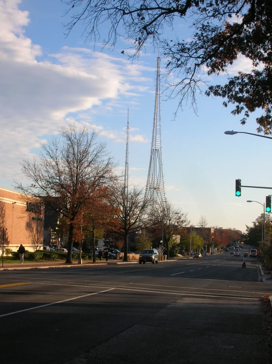 two traffic lights are on the green in a deserted neighborhood