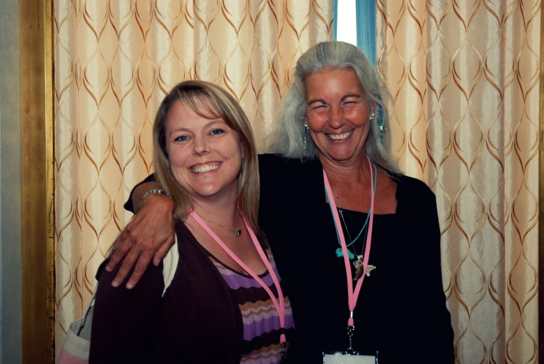 two women are standing next to each other with beaded necklaces on their neck