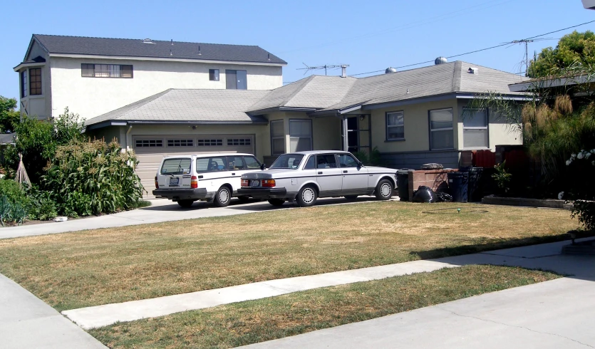 some very pretty looking houses with two trucks