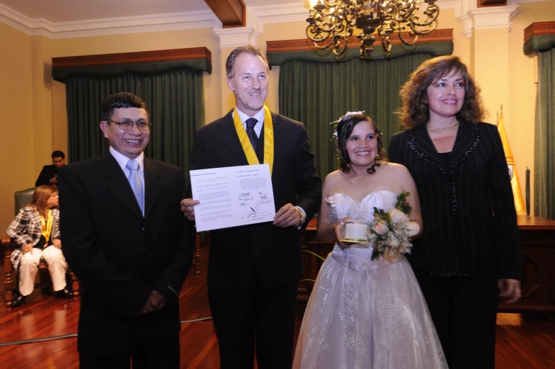 two couples getting married with a certificate