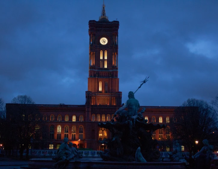 an old building with a clock at night