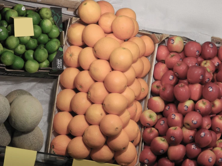 the fruits are in wooden crates and displayed