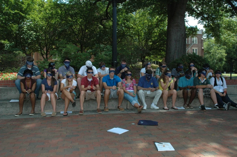 a group of people that are sitting next to a wall