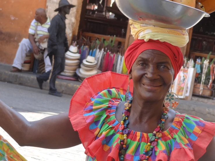 a woman in a bright dress is on the street