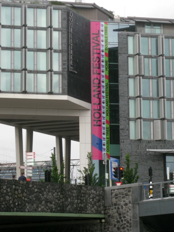 a building with a pink sign hanging off the side of it