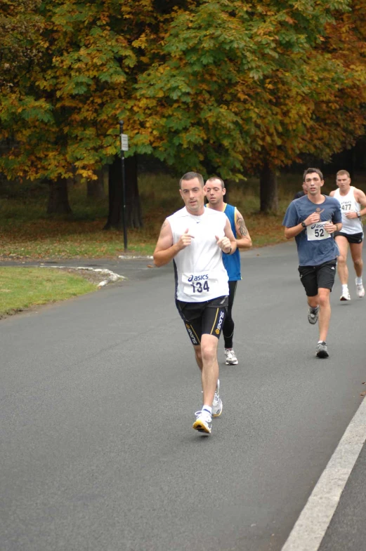 a group of people that are running in the street