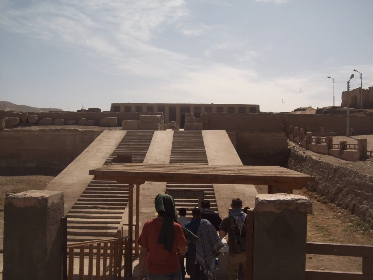 there are many people standing in front of a structure