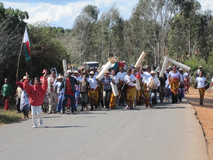 several people in costume are marching along the street