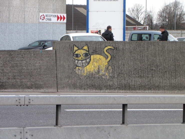 a graffiti covered wall with a cat in the center