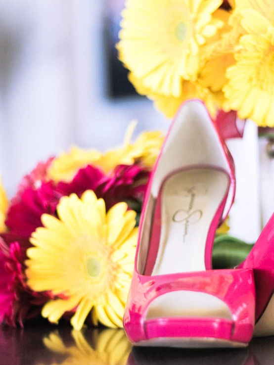 wedding shoes, bouquet and flowers in background