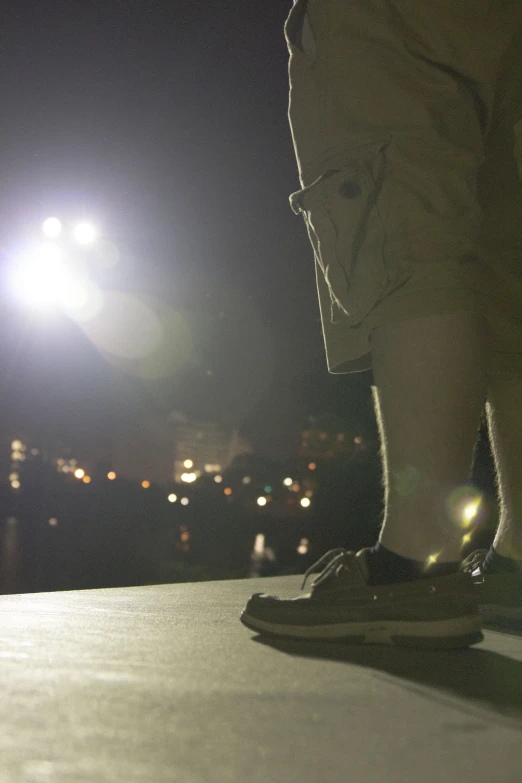 the bottom part of a skateboarder's shoes at night