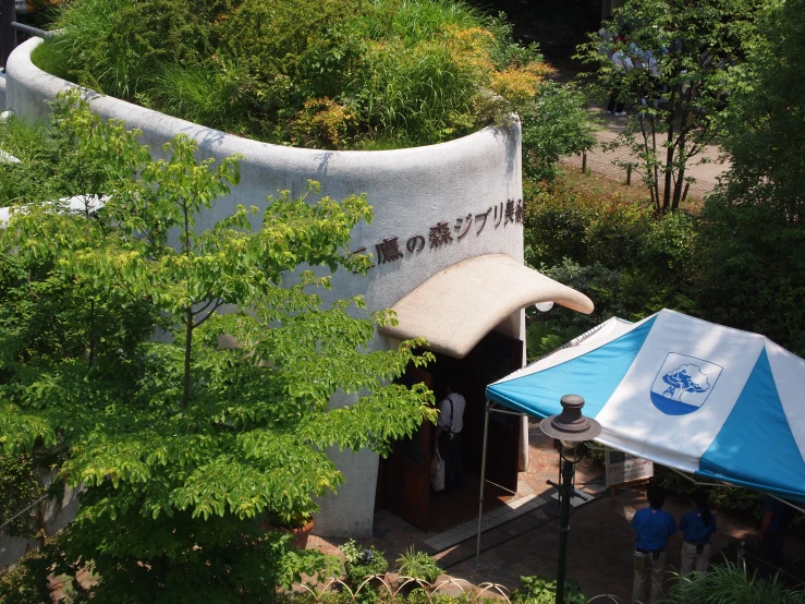 people are sitting at tables in front of an outdoor cafe