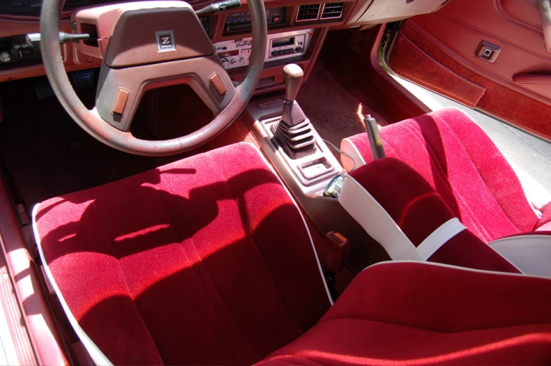 a red interior of a car and a steering wheel